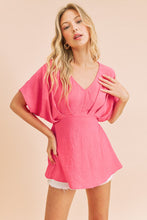 Fuchsia A V-Neck Dolman Short Sleeve Woven Blouse With Front Pleat Details